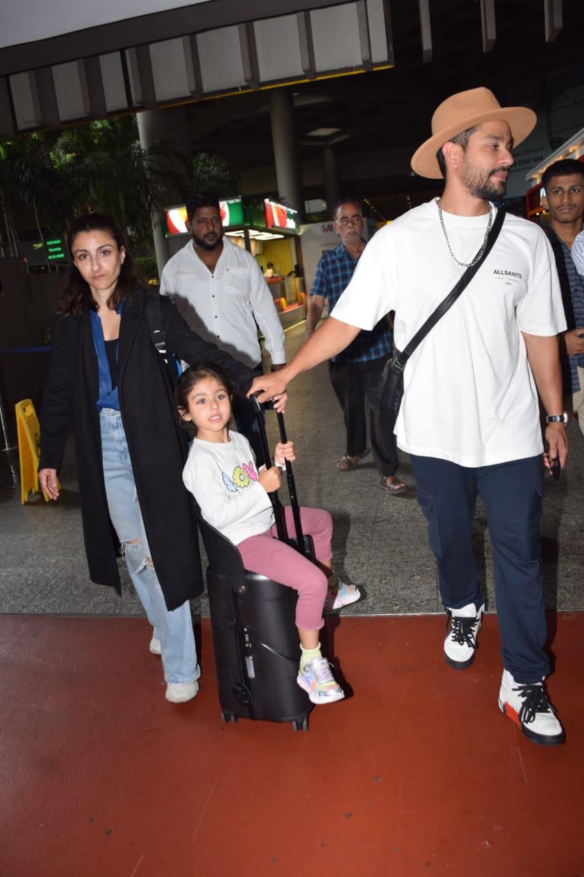 They wheeled around their adorable daughter while finding their way out of the airport